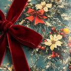 Vintage Christmas wrapping paper with poinsettias and a red velvet ribbon by Wrapped Studios.