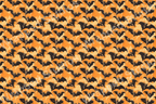Whimsical bat pattern in black on a blended gradient background of orange and cream.