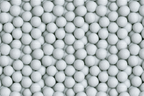 Seamless pattern of realistic white golf balls packed tightly together for a modern sports themed print.