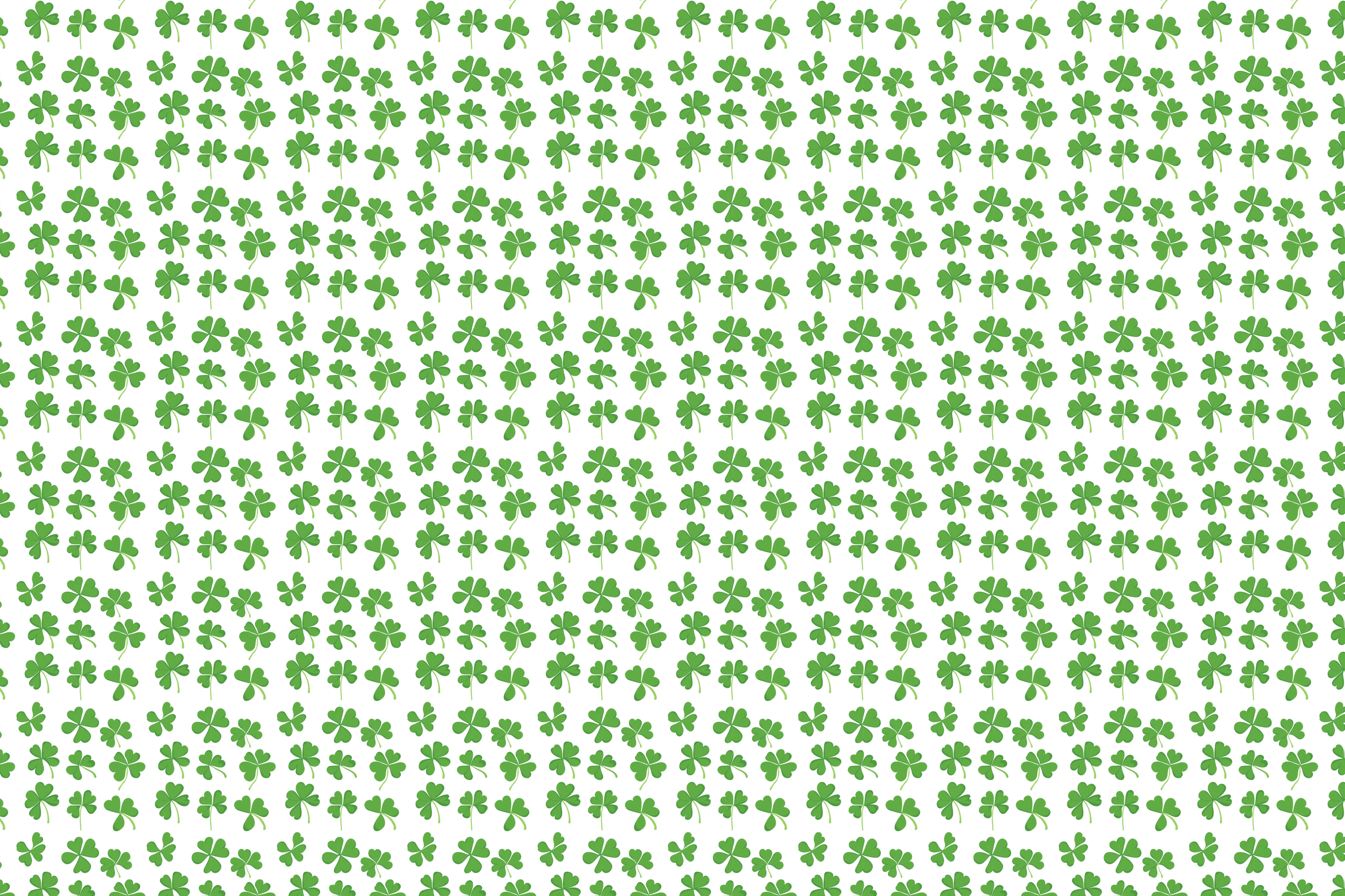 Pattern of green clover leaves on a white background. Wrapped Studios luxury wrapping paper.