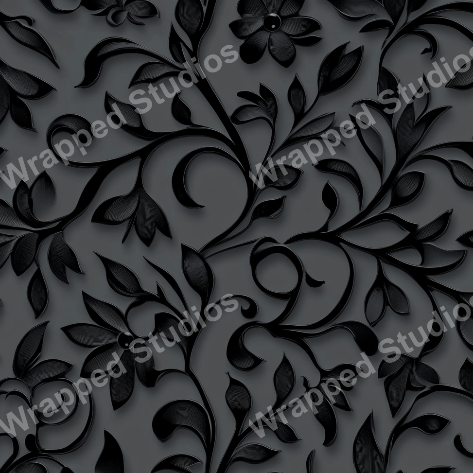 Elegant dark floral pattern with embossed black leaf and flower motifs on a gray background.