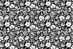 Monochrome floral pattern with white blossoms and foliage on a dark black ground.