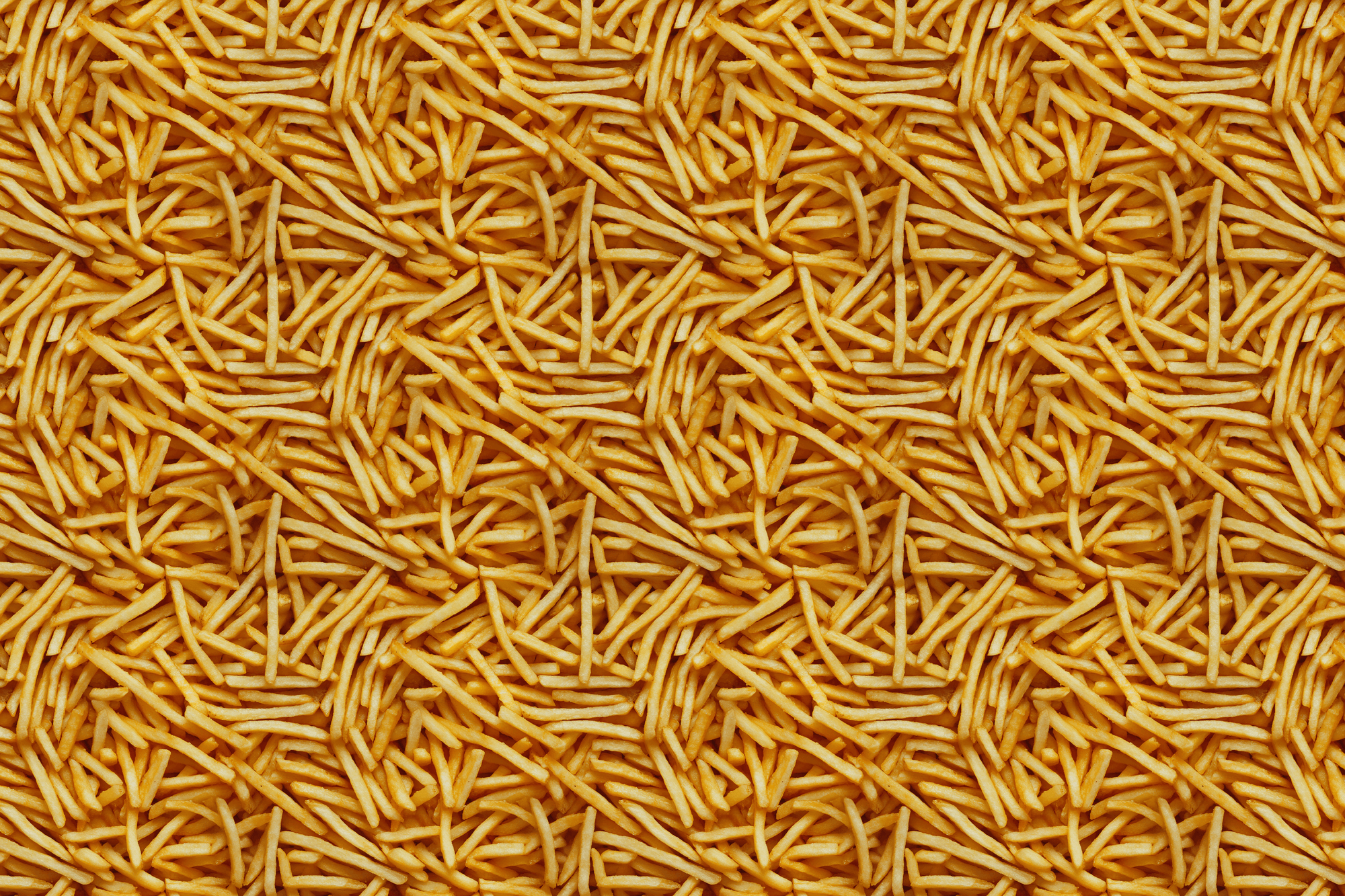 Close-up of a pile of yummy golden french fries. Wrapped Studios wrapping paper.