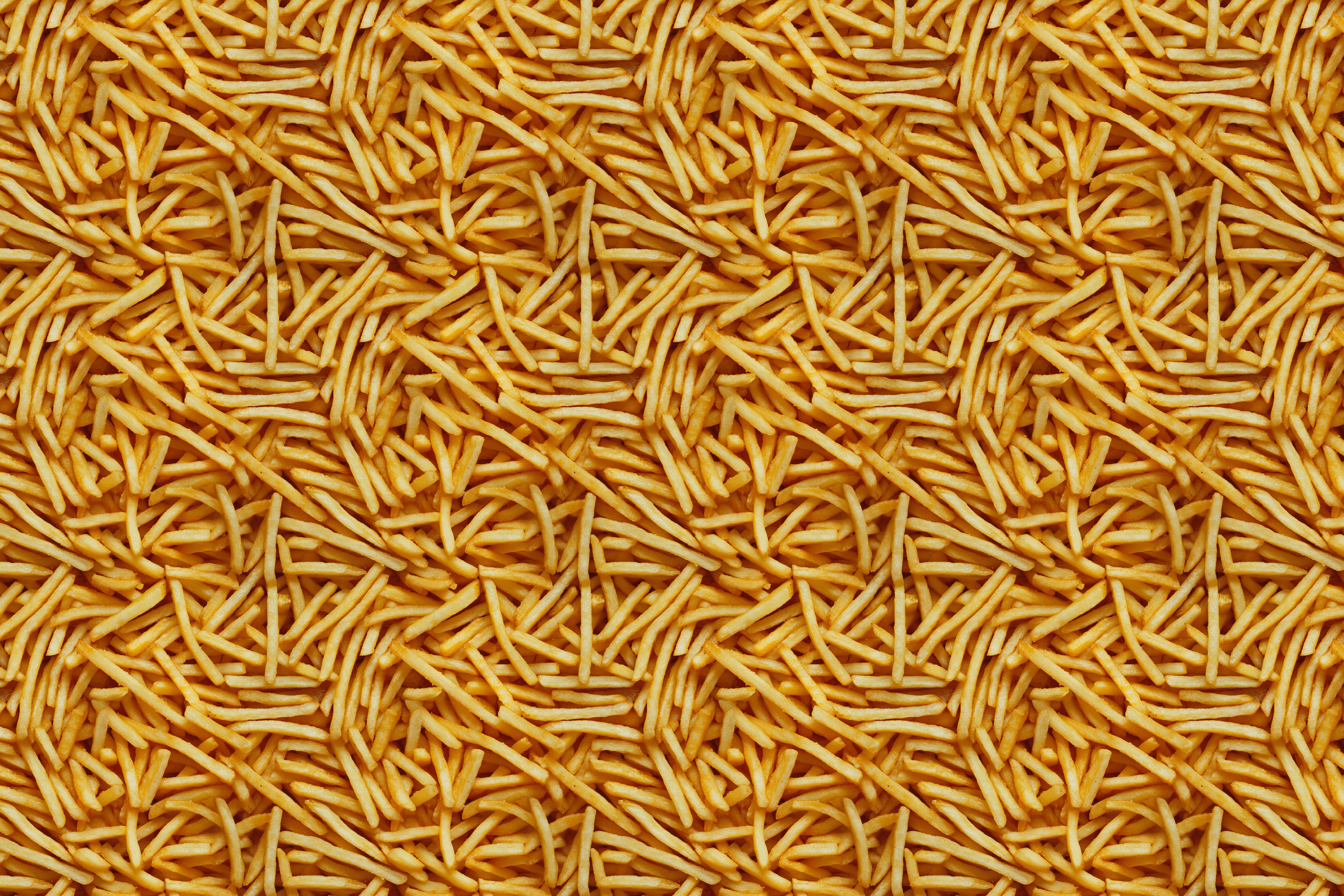 Close-up of a pile of yummy golden french fries. Wrapped Studios wrapping paper.