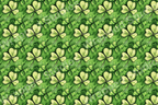 All-over lucky shamrock pattern in shades of green; a modern floral design.
