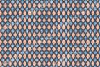 Vintage geometric pattern with distressed blue and peach woodgrain diamonds in a harlequin design.