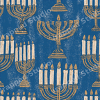 Vintage Hanukkah menorah pattern featuring gold block print candelabras on a distressed blue background.