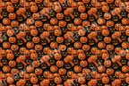 Spooky vintage Halloween pattern with seamless orange and black hand-drawn jack-o'-lantern pumpkins.