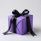 Purple gift box with a black ribbon on a light gray background