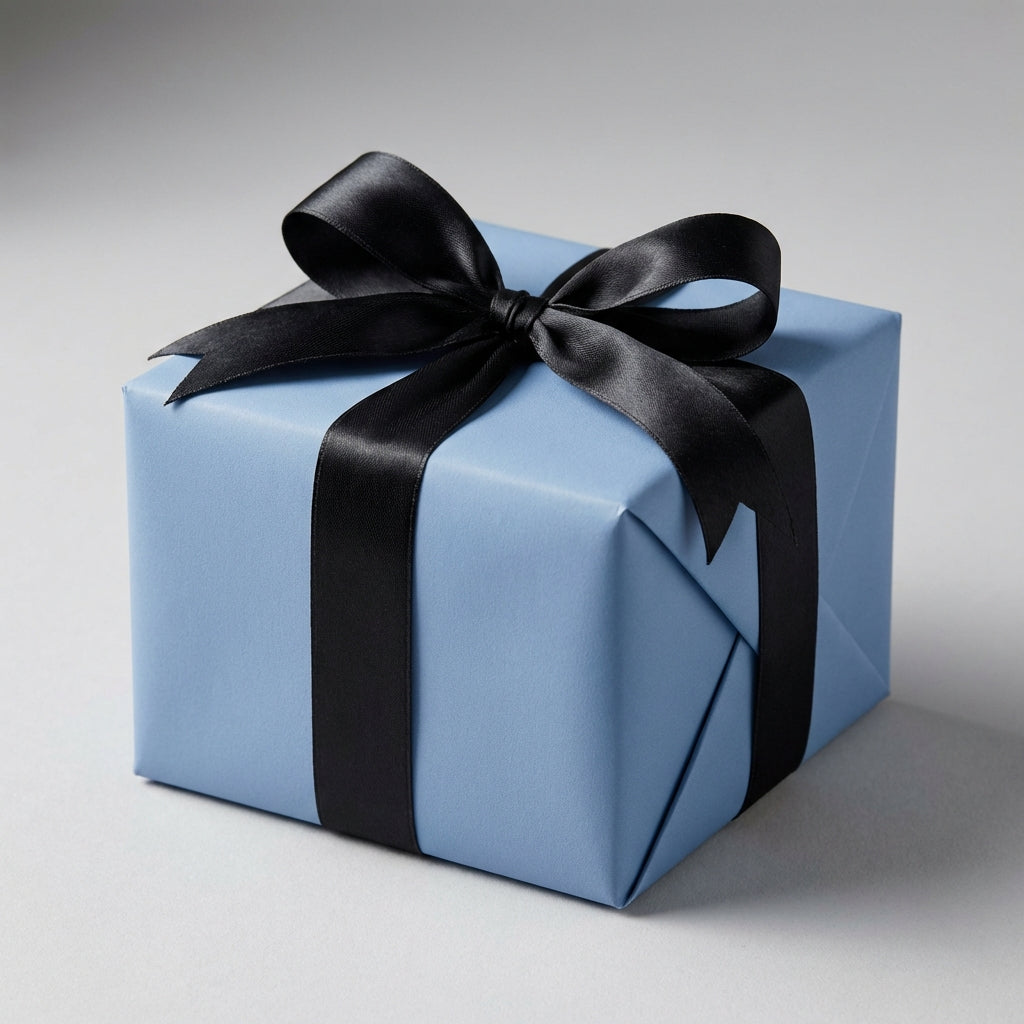 Cerulean Blue: Solid Color Gift Wrap on gift box with a black ribbon on a gray background