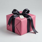 Dusty Rose gift box with a black ribbon and tag on a light gray background. Delicate Dusty Rose: Solid Color Gift Wrap