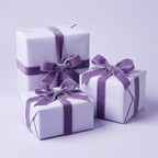 Three gifts with Lovely Lavender: Solid Color Wrapping Paper with purple ribbons on a light purple background