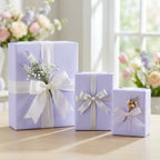 Three purple gift boxes with white ribbons on a wooden surface, with flowers in the background. Lovely Lavender: Solid Color Wrapping Paper