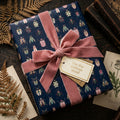 Navy wrapping paper with beetle print, tied with a blush velvet ribbon and a tag reading: "For the curious mind."
