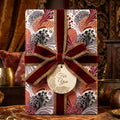 Luxury boho floral wrapping paper with a burgundy velvet bow by Wrapped Studios.