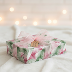 Modern pink and green geometric wrapping paper with a sheer pink ribbon and "Wrapped Studios" tag, perfect for luxury birthday or wedding gifts.