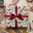 Modern geometric Christmas gift wrap with a festive red ribbon and bow, perfect for holiday presents.
