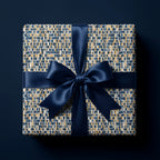 Square gift box with luxury navy blue, gold, and grey mosaic wrapping paper and a matching satin bow by Wrapped Studios.