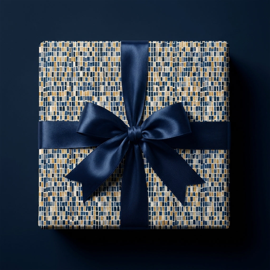 Square gift box with luxury navy blue, gold, and grey mosaic wrapping paper and a matching satin bow by Wrapped Studios.