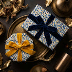 Luxury gift boxes wrapped in blue and gold mosaic pattern paper with velvet bows, by Wrapped Studios.