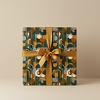 Gift wrapped in modern geometric wrapping paper with gold ribbon.