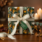 Elegant gift wrapped in geometric print wrapping paper with a cream ribbon and bow, set on a wooden table.