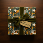 Modern gift wrapped in geometric teal & gold wrapping paper with olive velvet ribbon, perfect for birthday or special occasion.