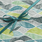 Modern geometric wrapping paper in teal, lime green, and grey, tied with a teal ribbon bow, perfect for a contemporary gift.
