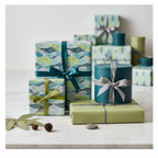 Modern abstract wave wrapping paper in teal, green, and gray, tied with satin and string, for elegant gifts or a stylish birthday.