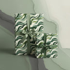 Wrapped presents in modern green wave wrapping paper with satin ribbons.