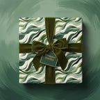 Elegant gift wrapped in green wave pattern paper, tied with velvet ribbon from Wrapped Studios.