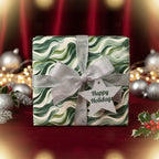 Green wave pattern Christmas gift wrap with silver ribbon bow and "Happy Holidays" tag.