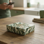 Wrapped gift in modern green wave wrapping paper and twine, from Wrapped Studios.