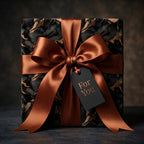 Elegant gift wrapped in black marble pattern paper, accented with a copper ribbon and "For You" tag.