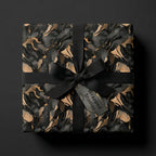 Luxury gift wrapped in Wrapped Studios black and gold marble pattern wrapping paper with a satin ribbon.
