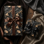 Luxury gift wrap featuring an abstract black and gold pattern with satin ribbon bows.