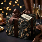 Elegant black and gold gift wrapped with brown ribbon and "Congrats" tag. Luxury gift wrap for special occasions.