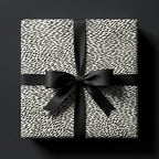 Modern black and white luxury wrapping paper with abstract dash pattern and satin bow by Wrapped Studios.