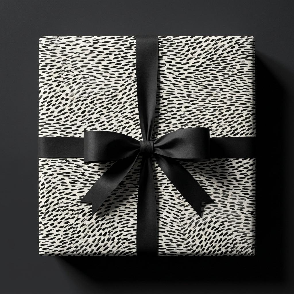 Modern black and white luxury wrapping paper with abstract dash pattern and satin bow by Wrapped Studios.