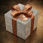 Modern black and white spotted wrapping paper with a luxury copper bow and Cheers tag by Wrapped Studios.