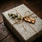 Modern black and white dash wrapping paper by Wrapped Studios, tied with rustic twine and eucalyptus.