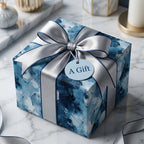 Luxury blue abstract wrapping paper with a silver satin bow on a gift box by Wrapped Studios.