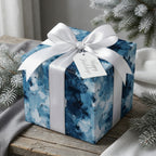 Luxury blue Christmas gift wrap with abstract brushstrokes and white satin bow by Wrapped Studios.