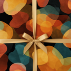 Modern abstract wrapping paper with a festive orange, teal, and black blob pattern, tied with an elegant gold satin ribbon and bow.