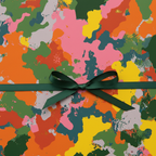 Abstract birthday wrapping paper with green ribbon bow; colorful gift wrap for celebrations.