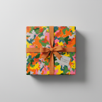 Colorful abstract gift wrap with orange ribbon and bow, perfect for birthday or any celebration.