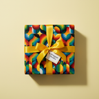 Square gift wrapped in colorful, geometric pattern paper with a yellow satin ribbon and bow.