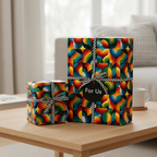 Gifts wrapped in colorful, modern wrapping paper with a geometric rainbow pattern and striped ribbon.