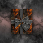 Square gift box in abstract orange wrapping paper with gray ribbon and "For You" tag.