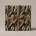 Abstract patterned gift wrapped in luxury wrapping paper with a brown ribbon.